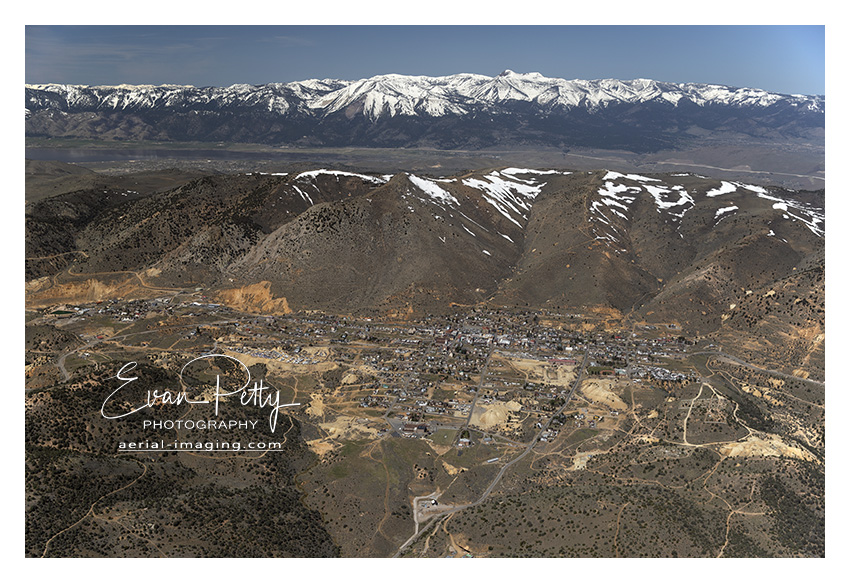Wide aerial view of Downtown Virginia City, Nevada aerial image photograph print view Washoe and Tahoe is behind