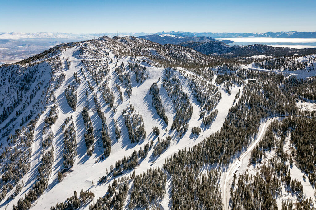 Mt Rose in winter aerial view with ski run and Lake Tahoe