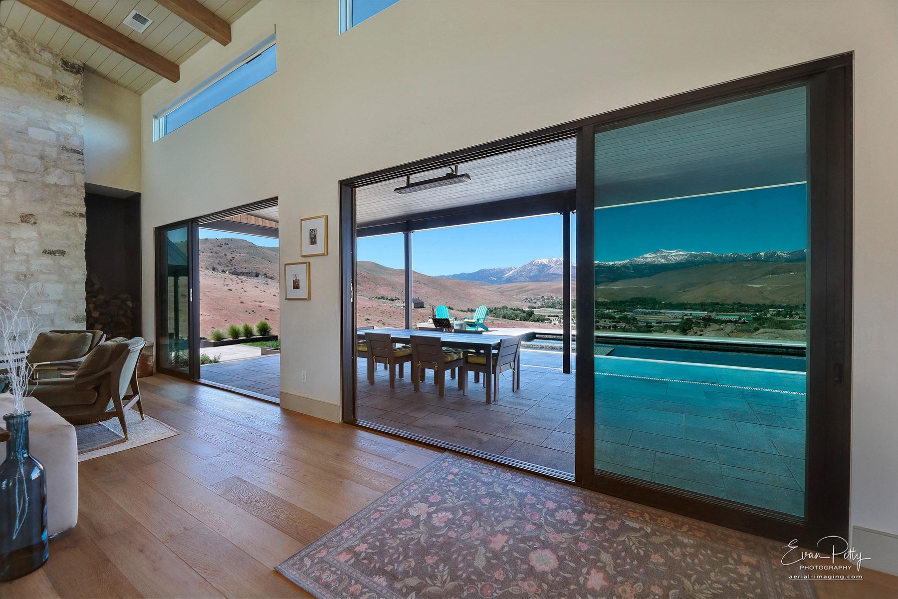 Living room view of the pool area and mountains.