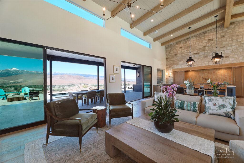 Living room and kitchen areas and mountain views through the windows.