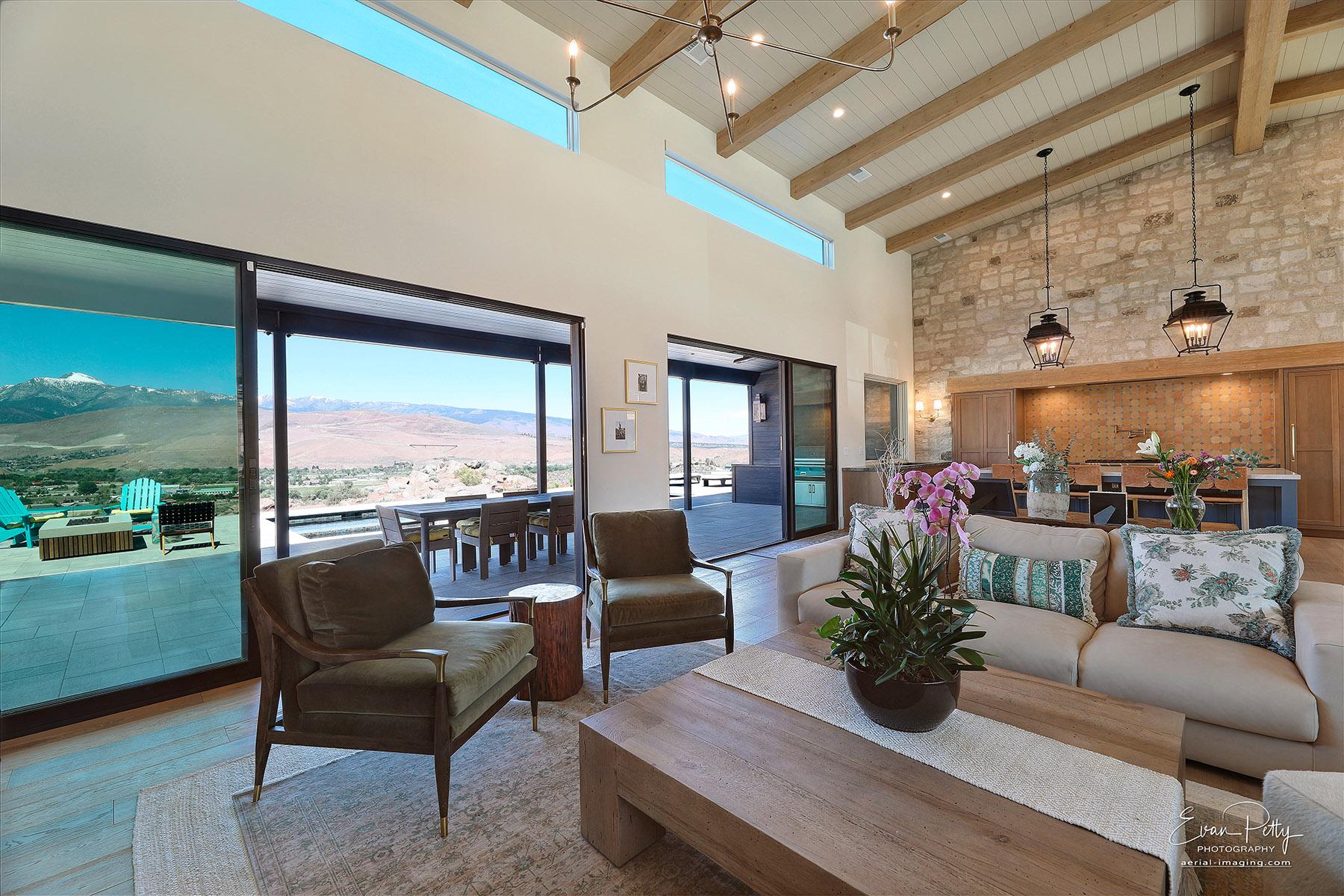 Living room and kitchen areas and mountain views through the windows.
