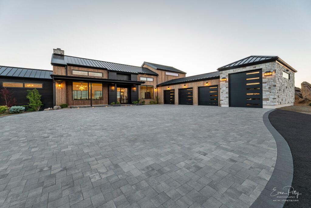 Stone driveway at dusk and the front of the house.