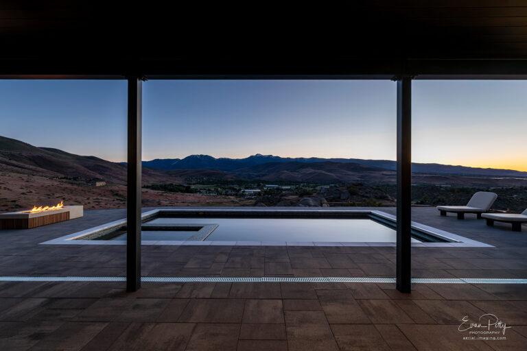Swimming pool reflecting light from the sky at twilight with Sierra Mountains in the background