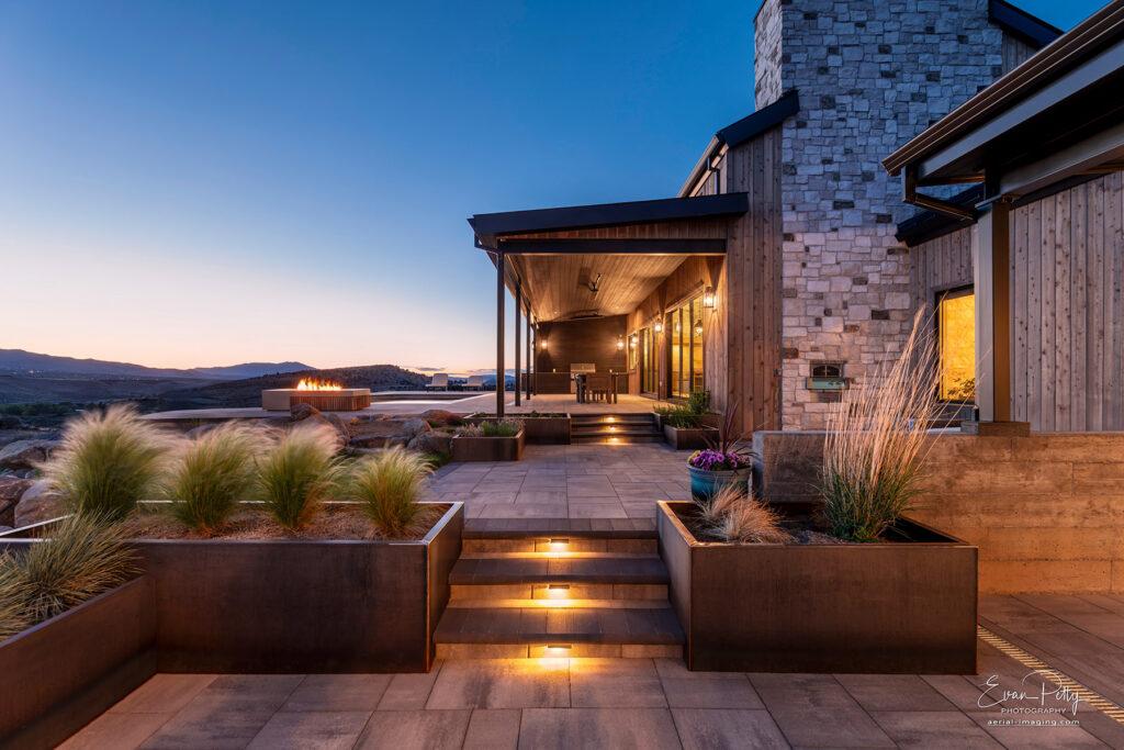 Dusk view of luxury house stairs backyard gardens and pool