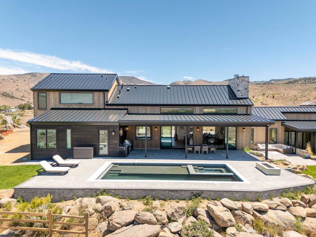 Drone view of house from the back showing the pool.