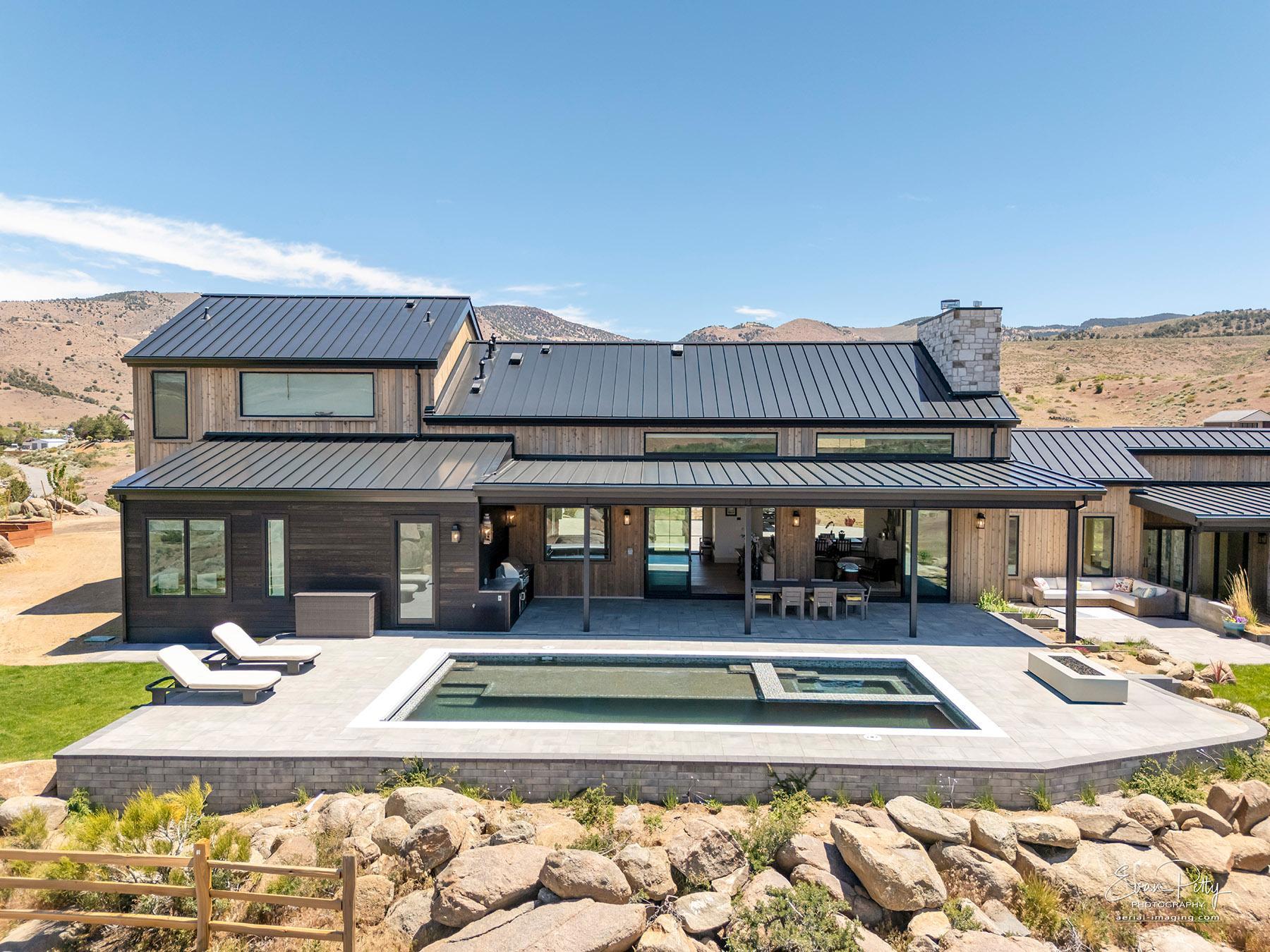 Drone view of house from the back showing the pool.